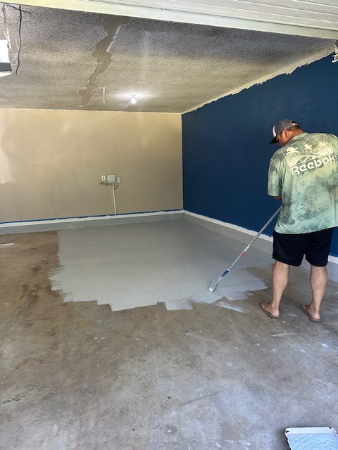 Team member painting a garage floor